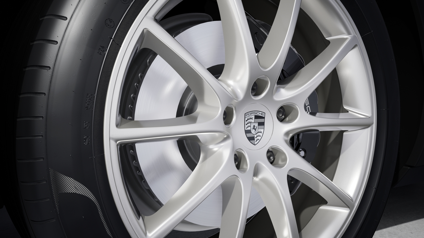 Wheel centre caps with monochrome Porsche crest