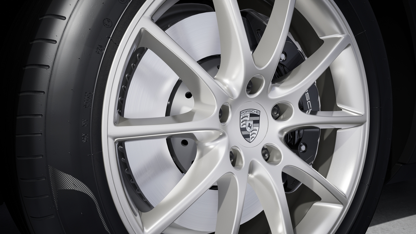 Wheel centre caps with monochrome Porsche crest