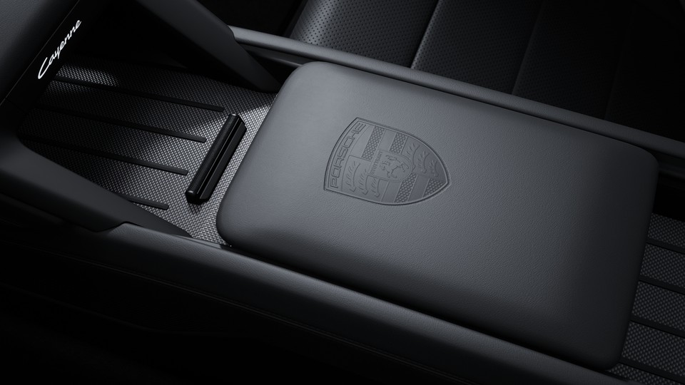 Porsche crest embossed on front centre console armrest