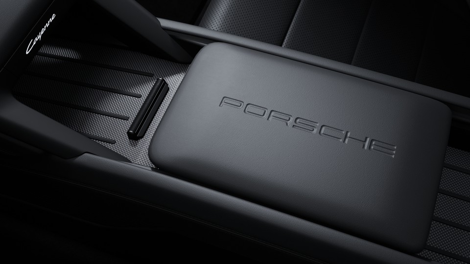 'PORSCHE' logo embossed on front centre console armrest